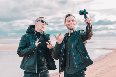 Young man photographing with mobile phone