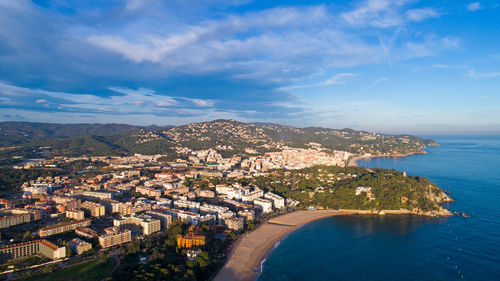 High angle view of cityscape by sea against sky