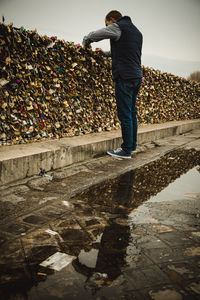 Low section of man standing on water