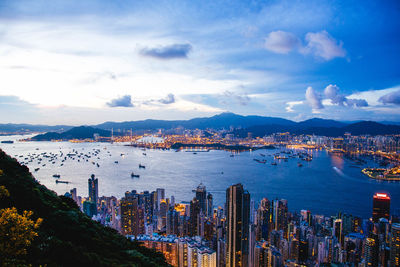 Buildings at victoria harbour during dusk in city