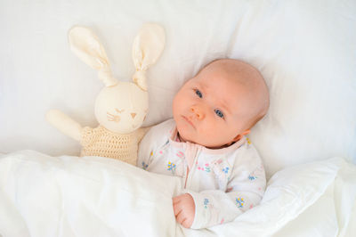 Portrait of cute baby boy sleeping on bed at home