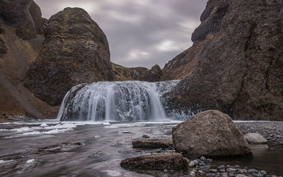 Full frame view of icy waterfall in rugged terrain