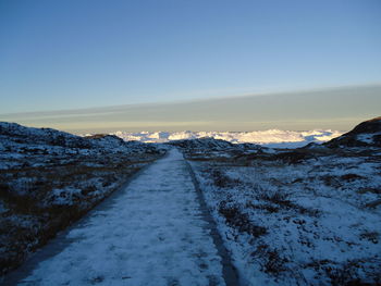 Scenic view of snow covered landscape against clear sky