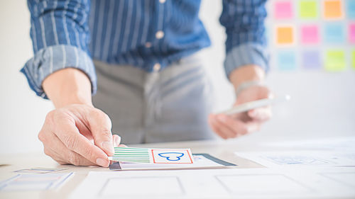 Midsection of man working on table