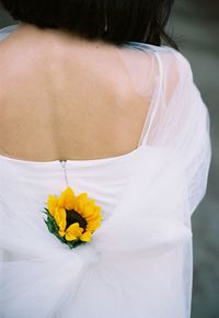 Rear view of woman standing by white flowering plant