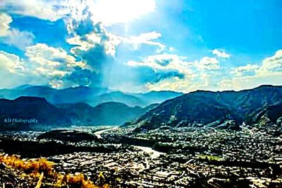 Aerial view of city against cloudy sky