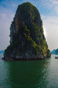 Rock formations by sea against sky