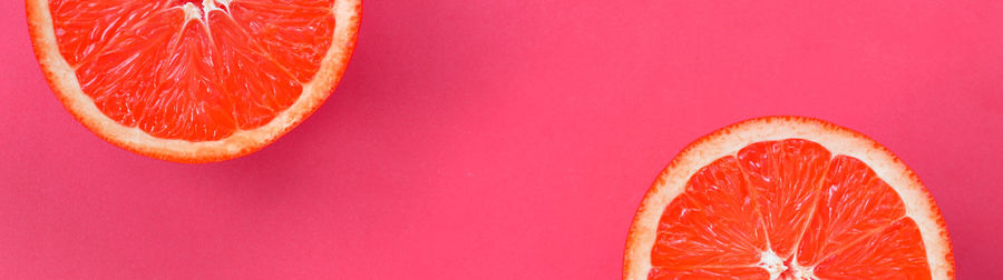 Close-up of orange fruit against red background