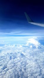 Aerial view of cloudscape over airplane wing