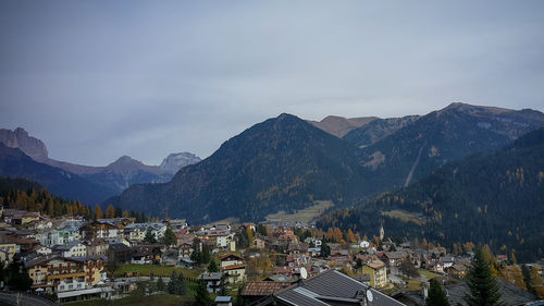 Townscape by mountains against sky