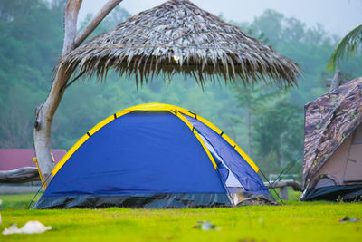 Scenic view of tent on field against sky