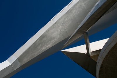 Low angle view of modern building against clear blue sky