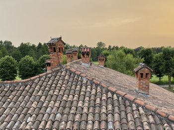 Old building by trees against clear sky