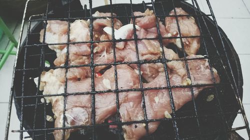 High angle view of meat on barbecue grill