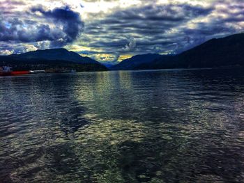 Scenic view of lake and mountains against sky