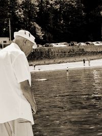 Man standing on shore against sky