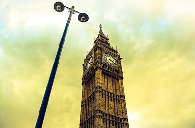 Low angle view of clock tower against cloudy sky