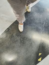 Low section of man wearing shoes