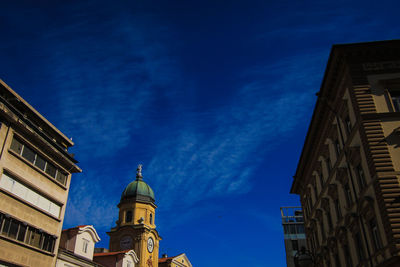 Low angle view of buildings against blue sky