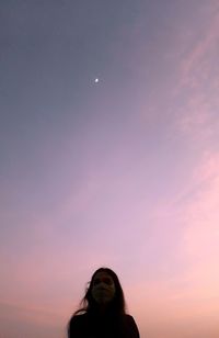 Portrait of woman standing against sky during sunset
