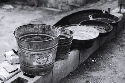 Buckets and frying pan on floor