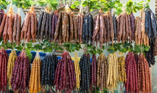 Close-up of multi colored candies hanging at market stall