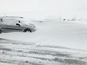 Car on snow covered road