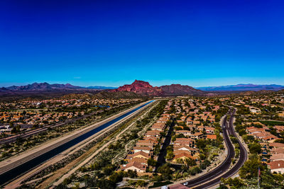 High angle view of railroad tracks against clear blue sky