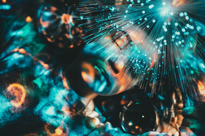 Close-up of woman with illuminated fiber optic in nightclub