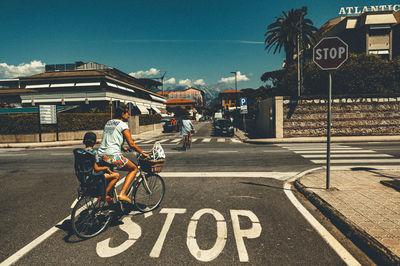 Man riding bicycle on road in city