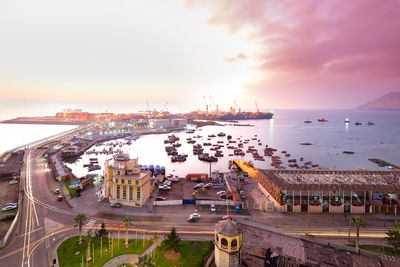 High angle view of city by sea against sky