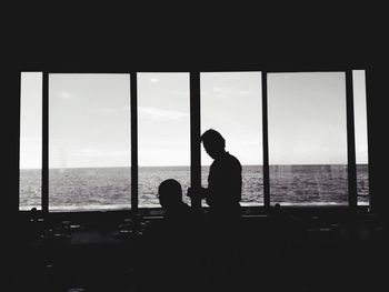 Rear view of a woman sitting on beach