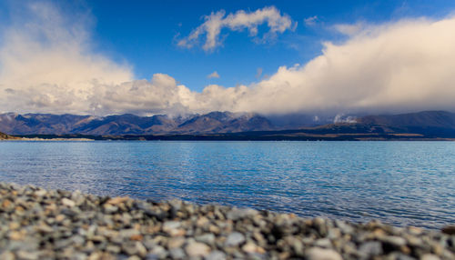 Scenic view of lake against cloudy sky