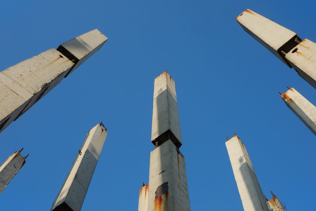 LOW ANGLE VIEW OF BUILDINGS AGAINST BLUE SKY