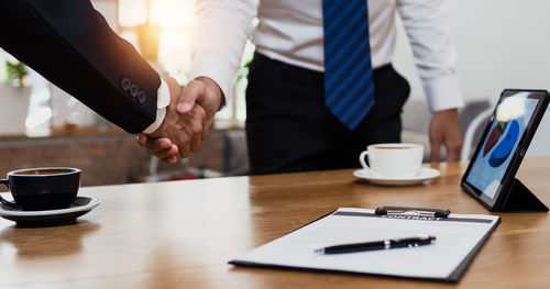 Midsection of lawyer working on table