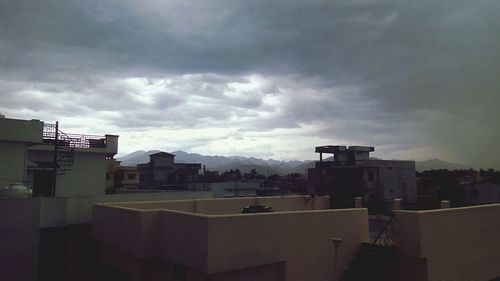 Buildings against cloudy sky