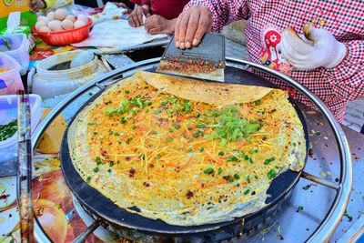 Pancake vendors at an open-air traditional market in urumqi, xinjiang, china