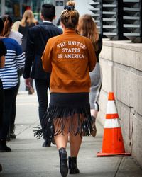 Rear view of people walking on pathway