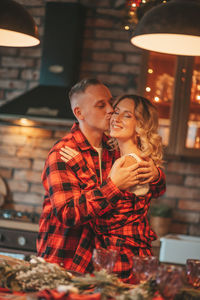 Candid authentic happy married couple spends time alone at lodge xmas decorated