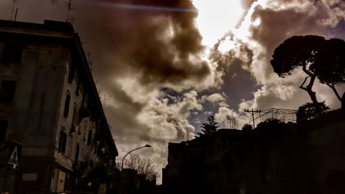 Low angle view of building against cloudy sky