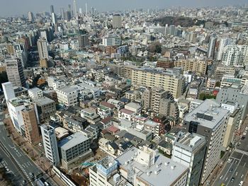 High angle view of crowd and buildings in city