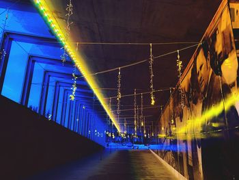 Low angle view of illuminated bridge at night