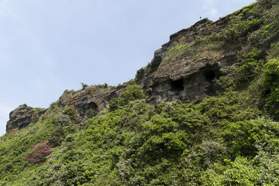 Low angle view of rock formation against sky