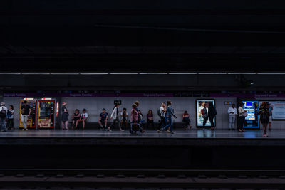 People waiting at railroad station platform