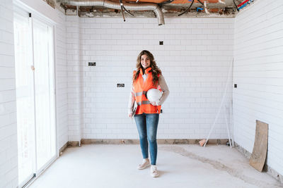 Inspector or architect professional woman checking kitchen at construction site. home improvement