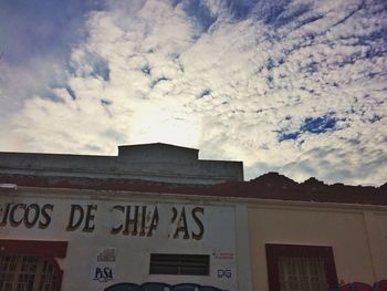 Low angle view of building against cloudy sky