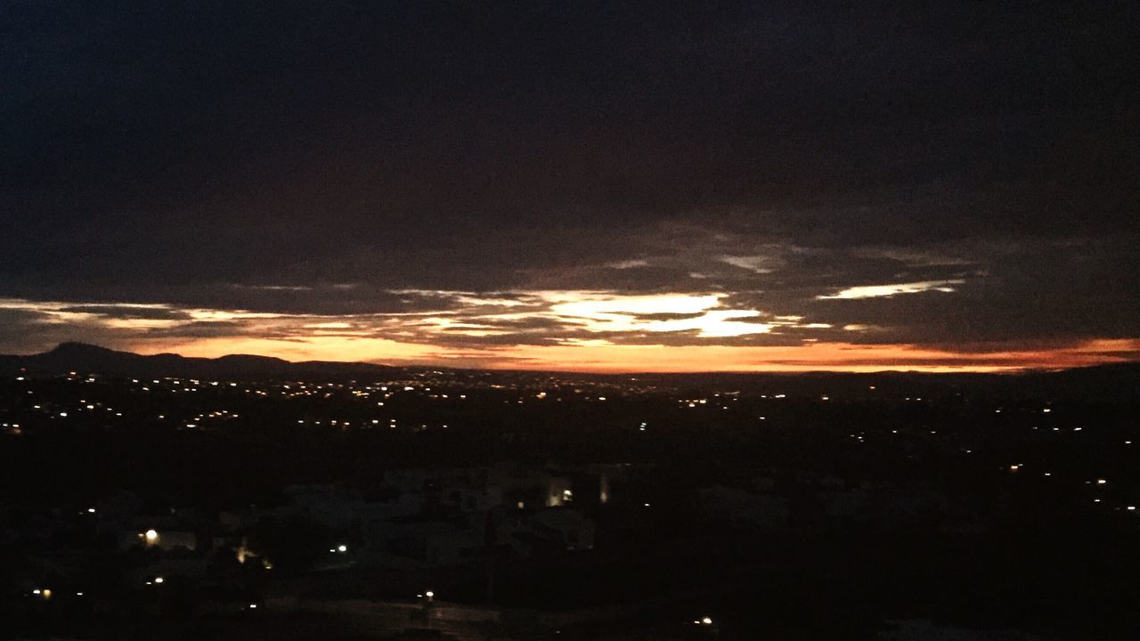 sunset, beauty in nature, sky, nature, silhouette, tranquility, tranquil scene, cloud - sky, scenics, no people, outdoors, illuminated, night, scenery, cityscape