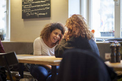 Friends talking in restaurant