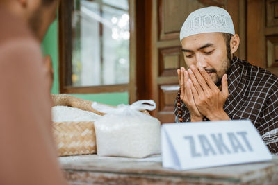 Young men praying in mosque