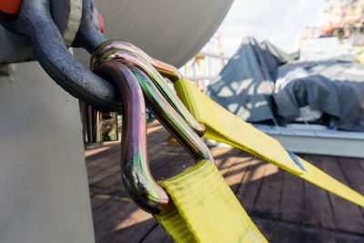 Close-up of metal chain hanging on railing